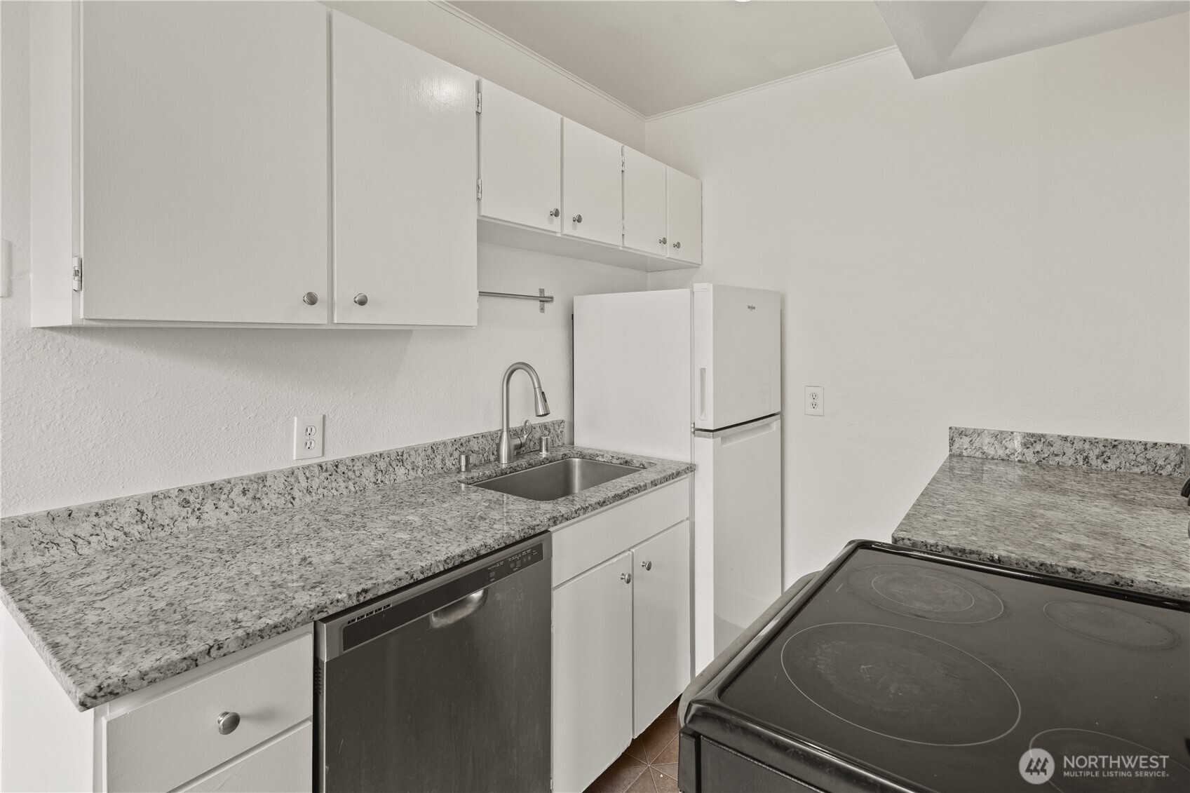 741 Federal Avenue East Seattle, WA 98102 - Photo 6 of 21 a kitchen with stainless steel appliances granite countertop a sink stove and cabinets
