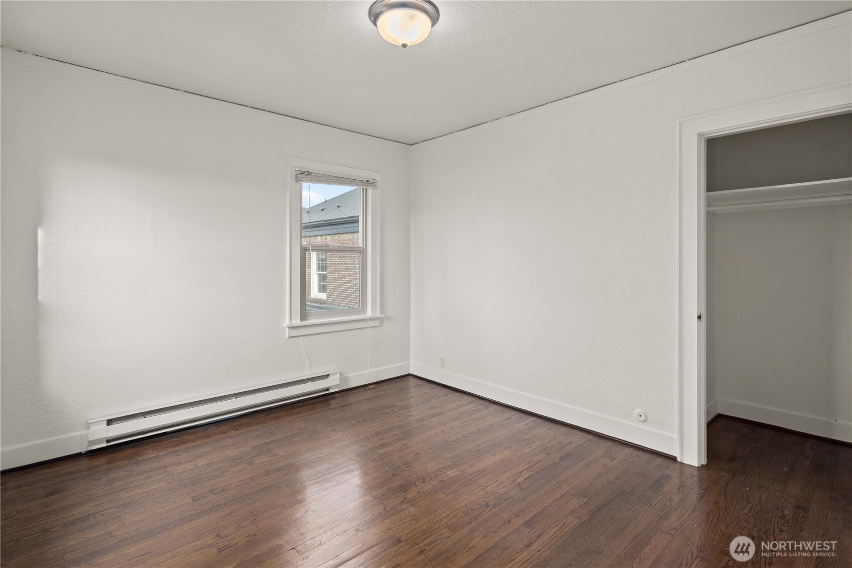 741 Federal Avenue East Seattle, WA 98102 - Photo 10 of 21 an empty room with wooden floor and windows