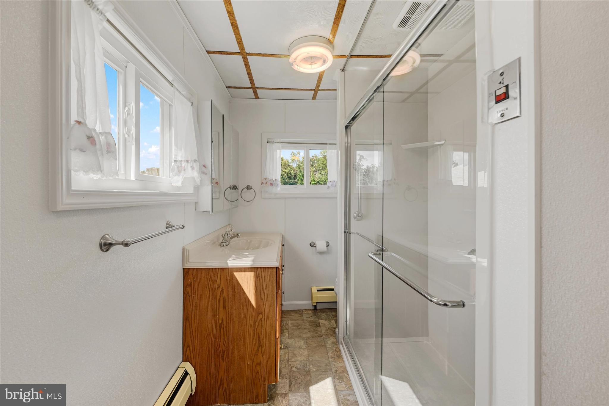 7848 Oakdale Avenue Rosedale, MD 21237 - Photo 13 of 46 a bathroom with a mirror and a shower