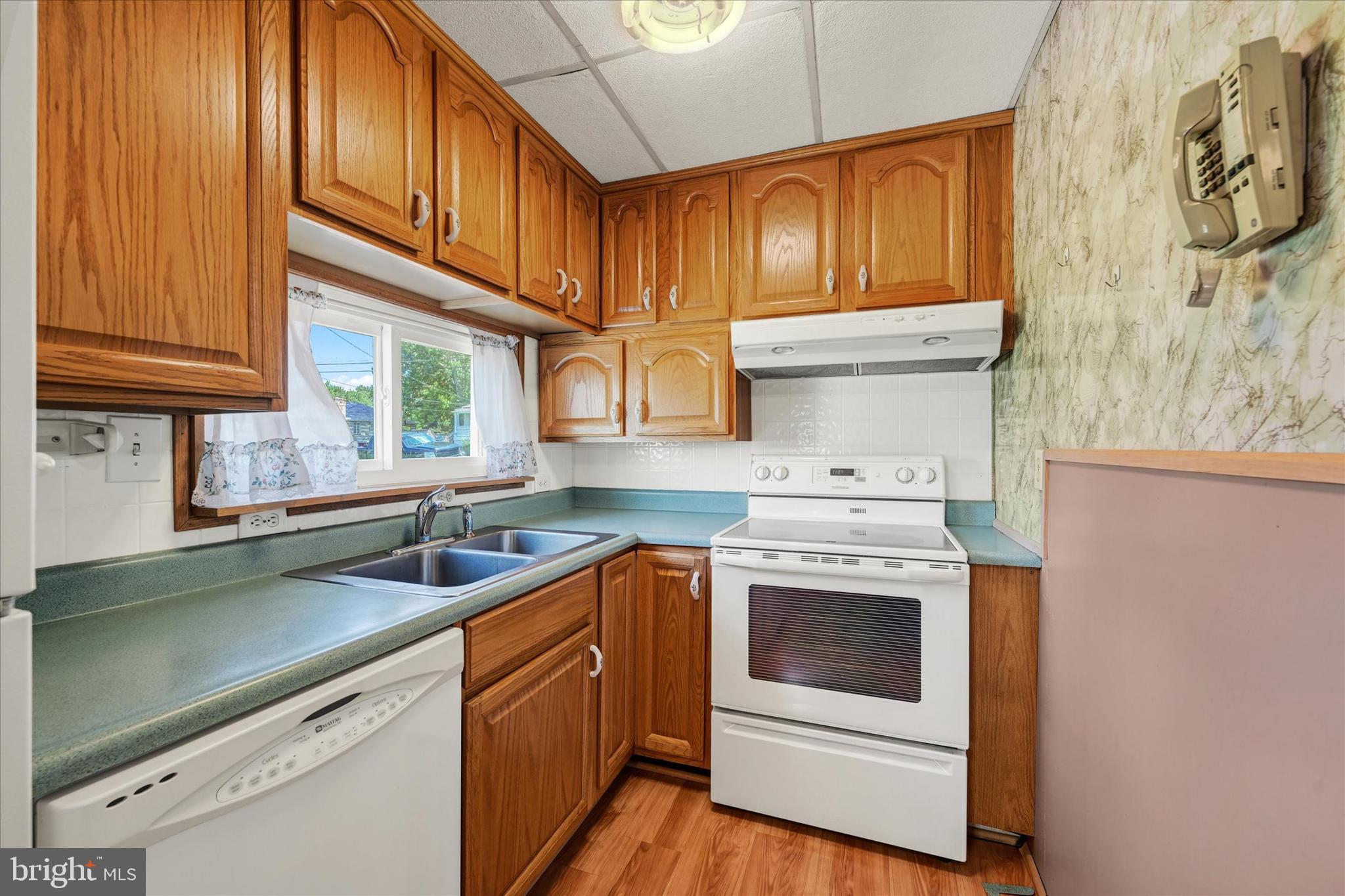7848 Oakdale Avenue Rosedale, MD 21237 - Photo 14 of 46 a kitchen with a sink stove and cabinets