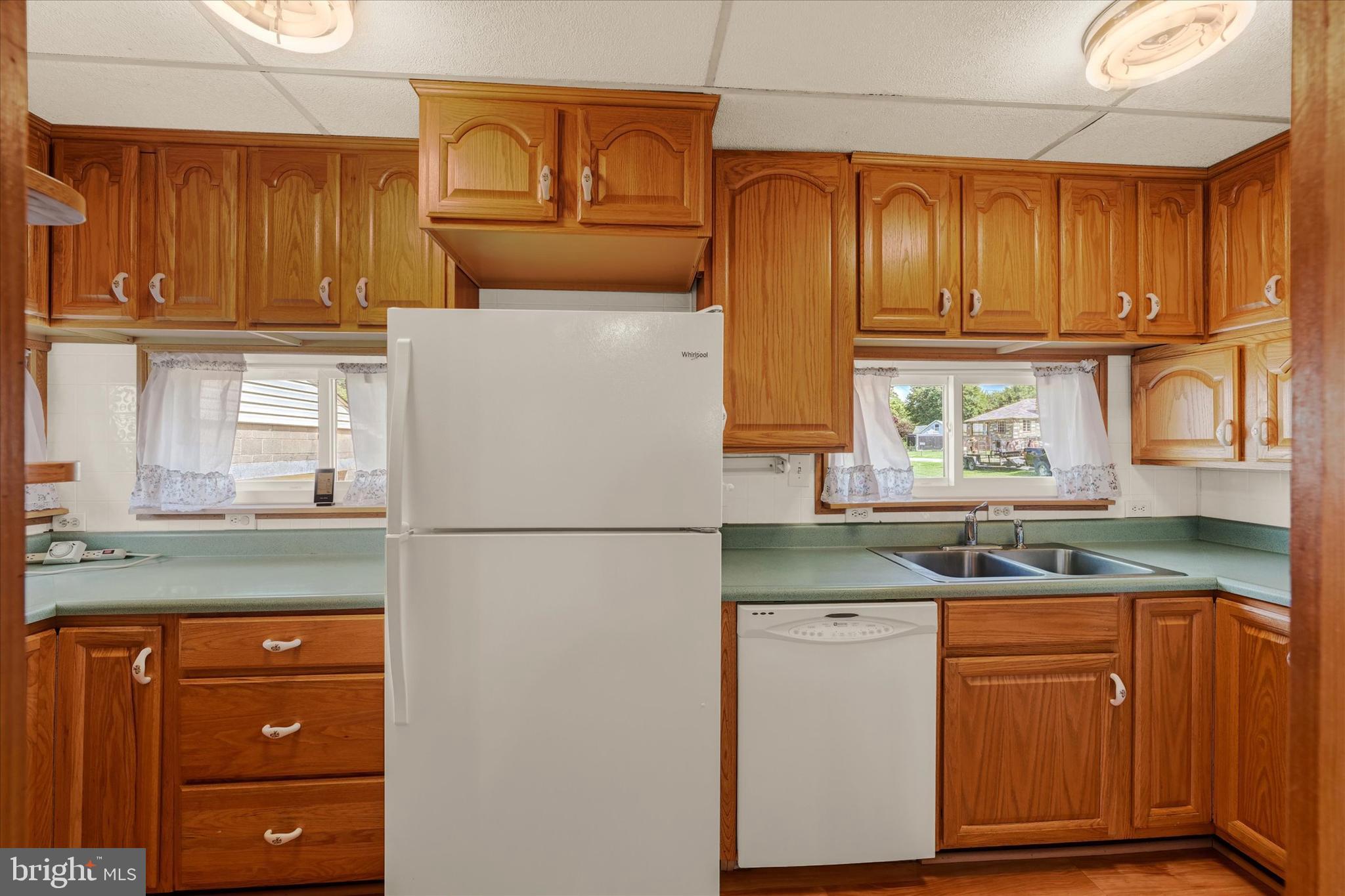 7848 Oakdale Avenue Rosedale, MD 21237 - Photo 16 of 46 a kitchen with granite countertop wooden cabinets and white appliances