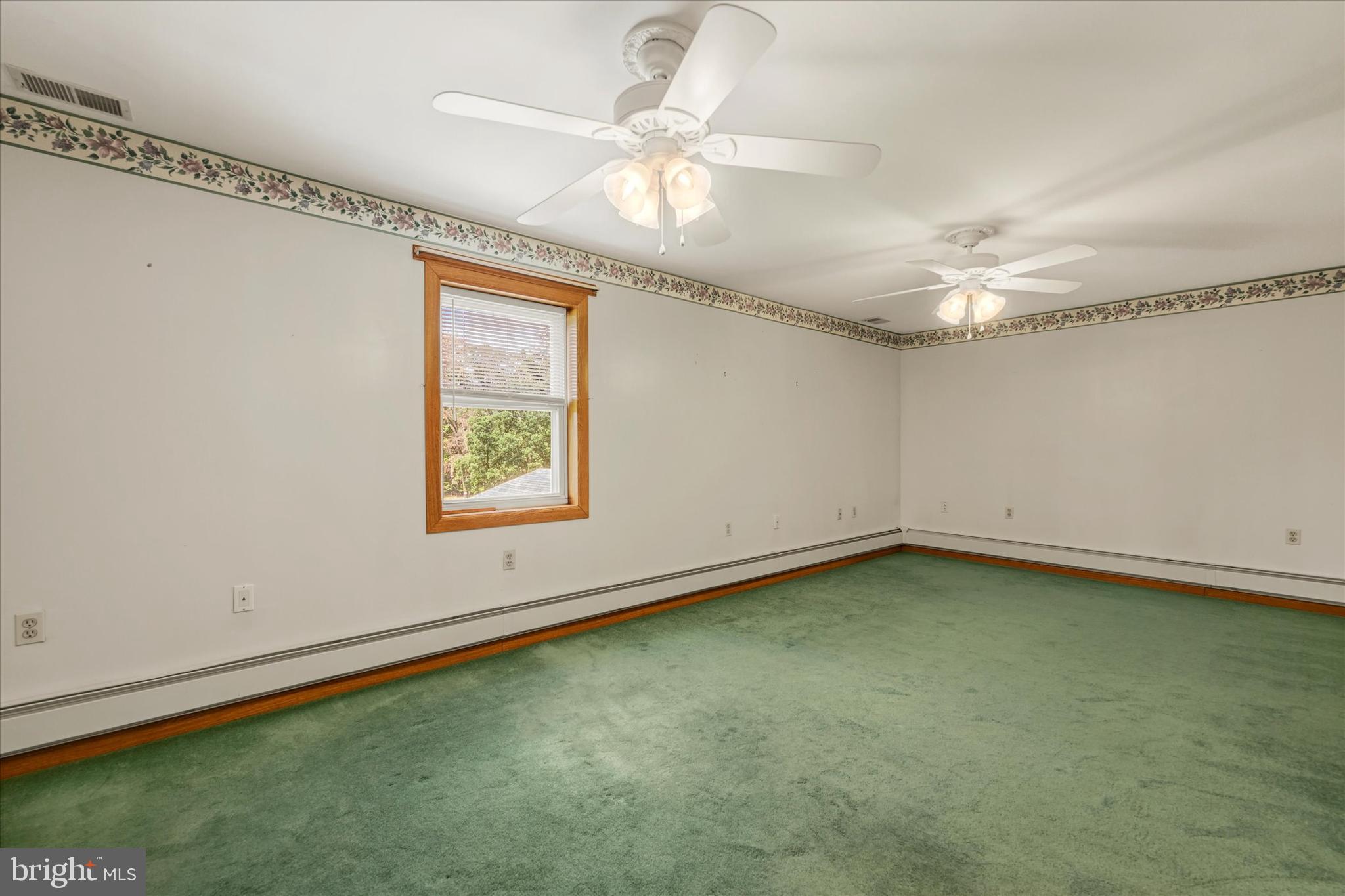 7848 Oakdale Avenue Rosedale, MD 21237 - Photo 17 of 46 a view of an empty room with window and chandelier fan