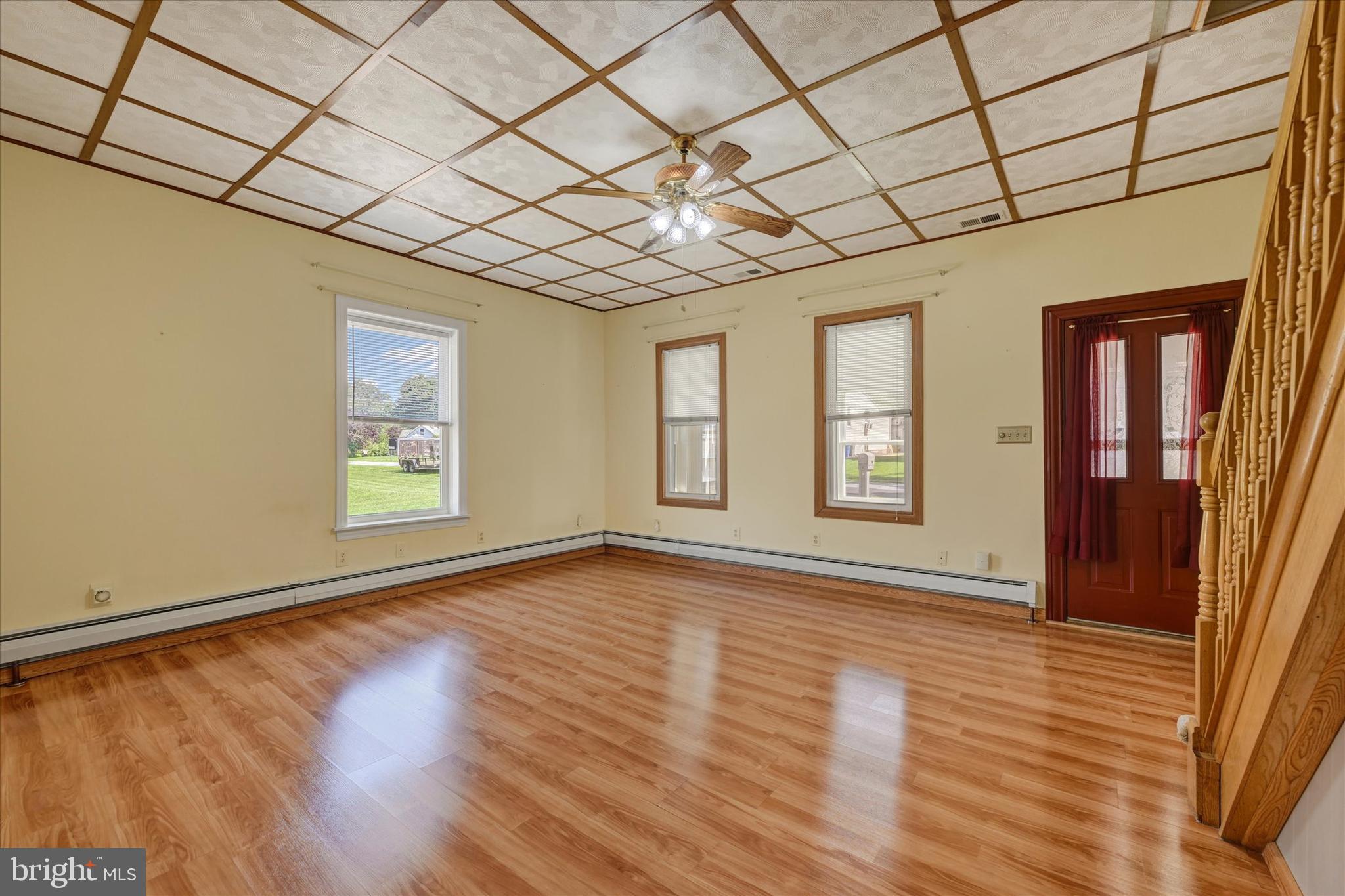 7848 Oakdale Avenue Rosedale, MD 21237 - Photo 5 of 46 a view of an empty room with a window and wooden floor
