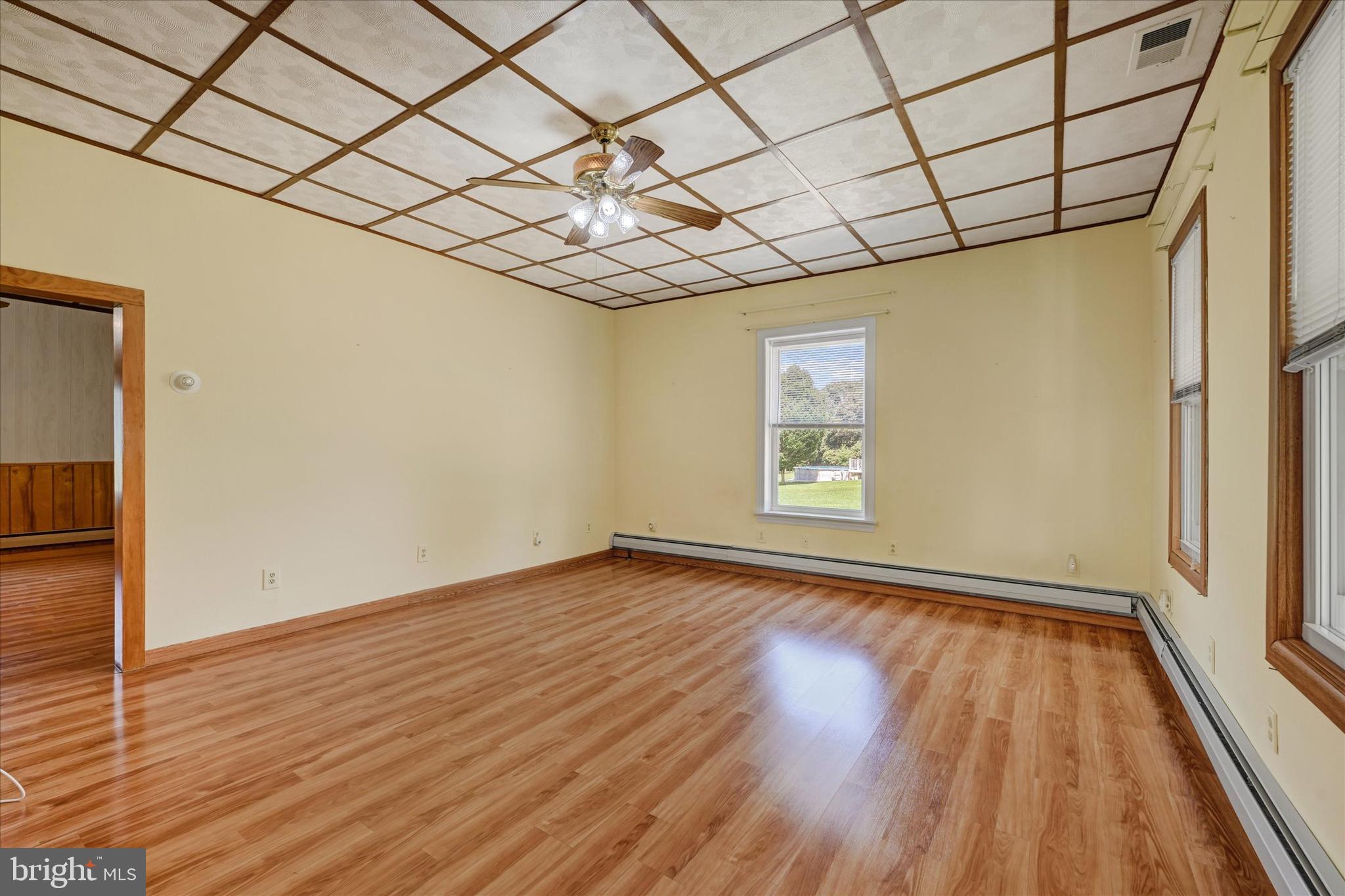 7848 Oakdale Avenue Rosedale, MD 21237 - Photo 7 of 46 a view of an empty room with wooden floor and a window