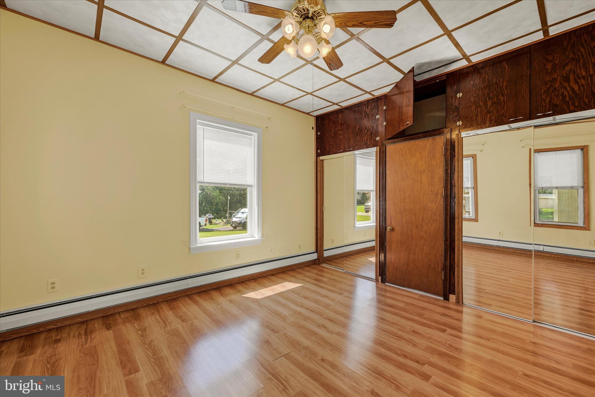 7848 Oakdale Avenue Rosedale, MD 21237 - Photo 8 of 46 a view of an empty room with wooden floor and a window