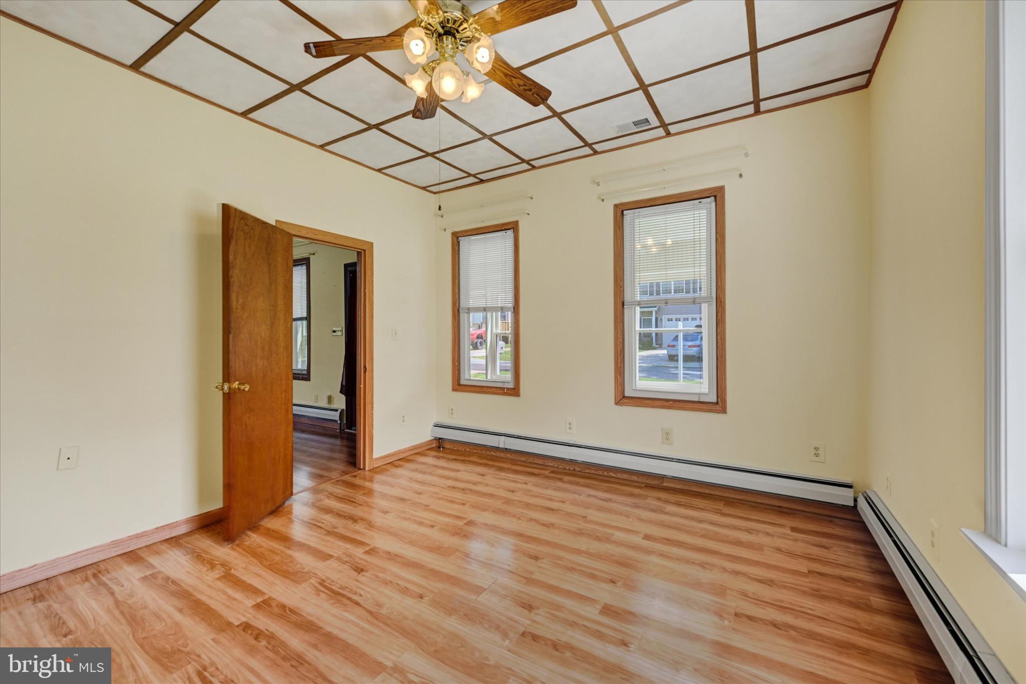 7848 Oakdale Avenue Rosedale, MD 21237 - Photo 9 of 46 a view of an empty room with wooden floor and a window