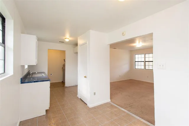 a kitchen with sink cabinets and window