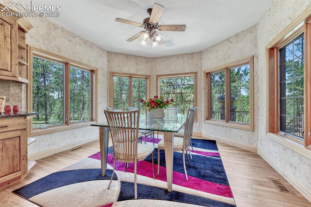 17890 Queensmere Drive Monument, CO 80132 - Photo 12 of 50 a view of a living room and a dining room with wooden floor