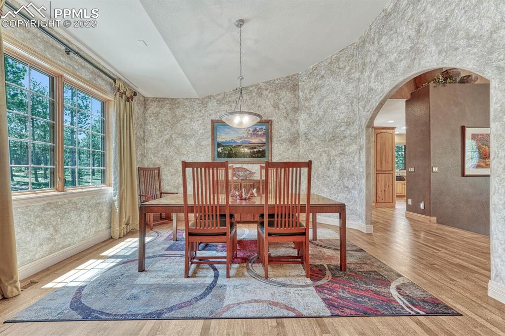 17890 Queensmere Drive Monument, CO 80132 - Photo 14 of 50 a dining room with furniture and wooden floor