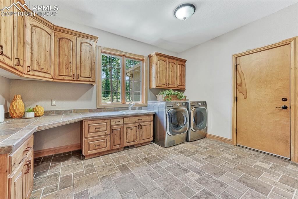 17890 Queensmere Drive Monument, CO 80132 - Photo 17 of 50 a kitchen with stainless steel appliances granite countertop a sink a stove and a refrigerator