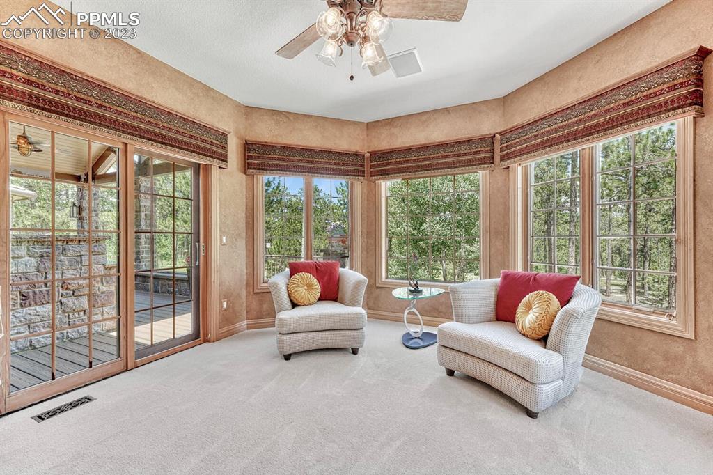 17890 Queensmere Drive Monument, CO 80132 - Photo 20 of 50 a living room with furniture and a large window