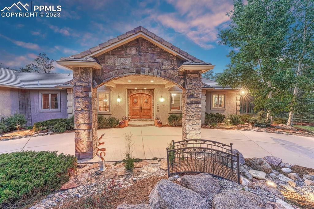 17890 Queensmere Drive Monument, CO 80132 - Photo 2 of 50 a front view of a house with a garden