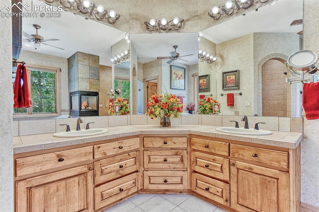 17890 Queensmere Drive Monument, CO 80132 - Photo 23 of 50 a bathroom with a sink double vanity granite and a mirror