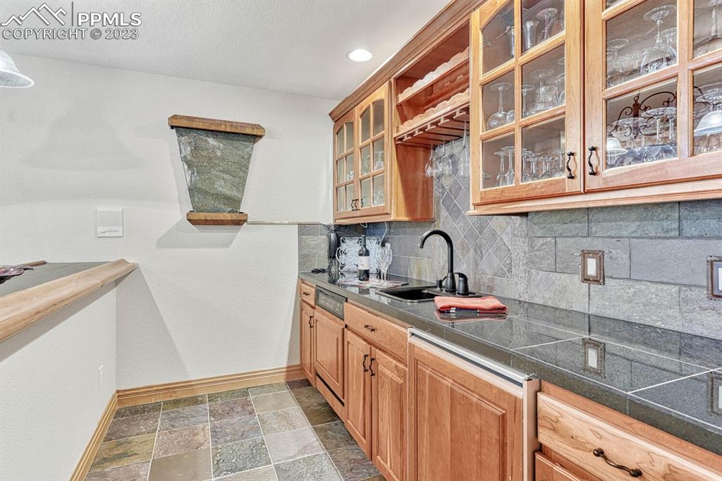 17890 Queensmere Drive Monument, CO 80132 - Photo 28 of 50 a kitchen with stainless steel appliances granite countertop a sink and a stove