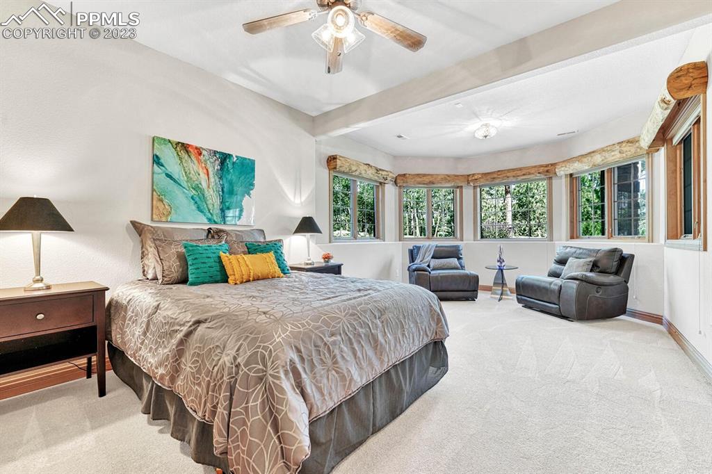 17890 Queensmere Drive Monument, CO 80132 - Photo 34 of 50 a spacious bedroom with a bed and a couch