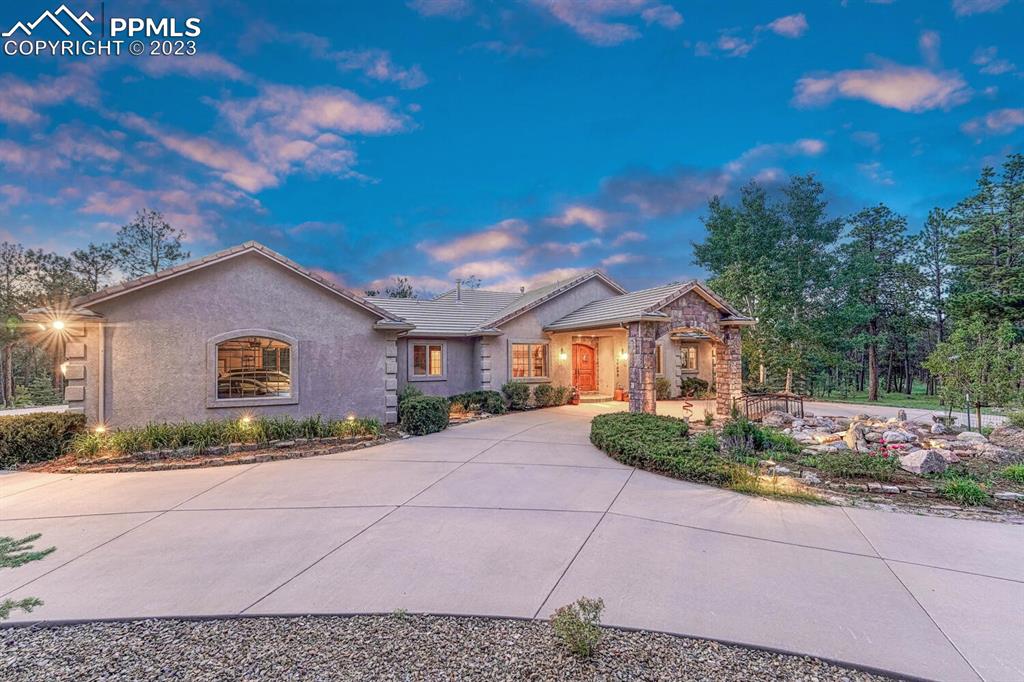 17890 Queensmere Drive Monument, CO 80132 - Photo 40 of 50 a front view of a house with a yard