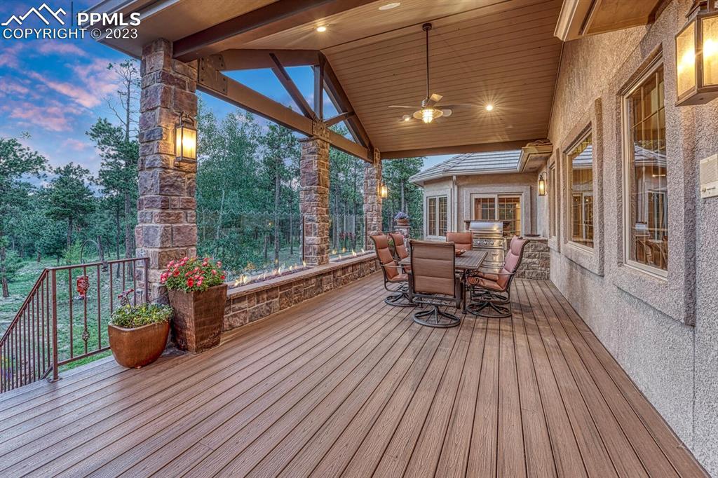 17890 Queensmere Drive Monument, CO 80132 - Photo 42 of 50 a view of a patio with a table chairs and a barbeque