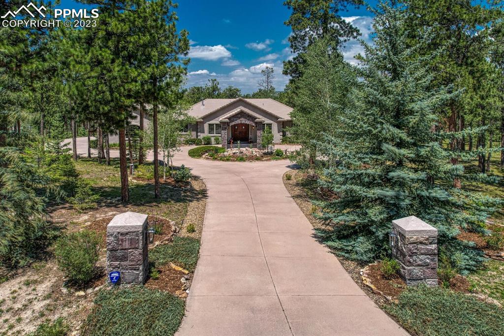 17890 Queensmere Drive Monument, CO 80132 - Photo 48 of 50 a pathway of a house with a yard