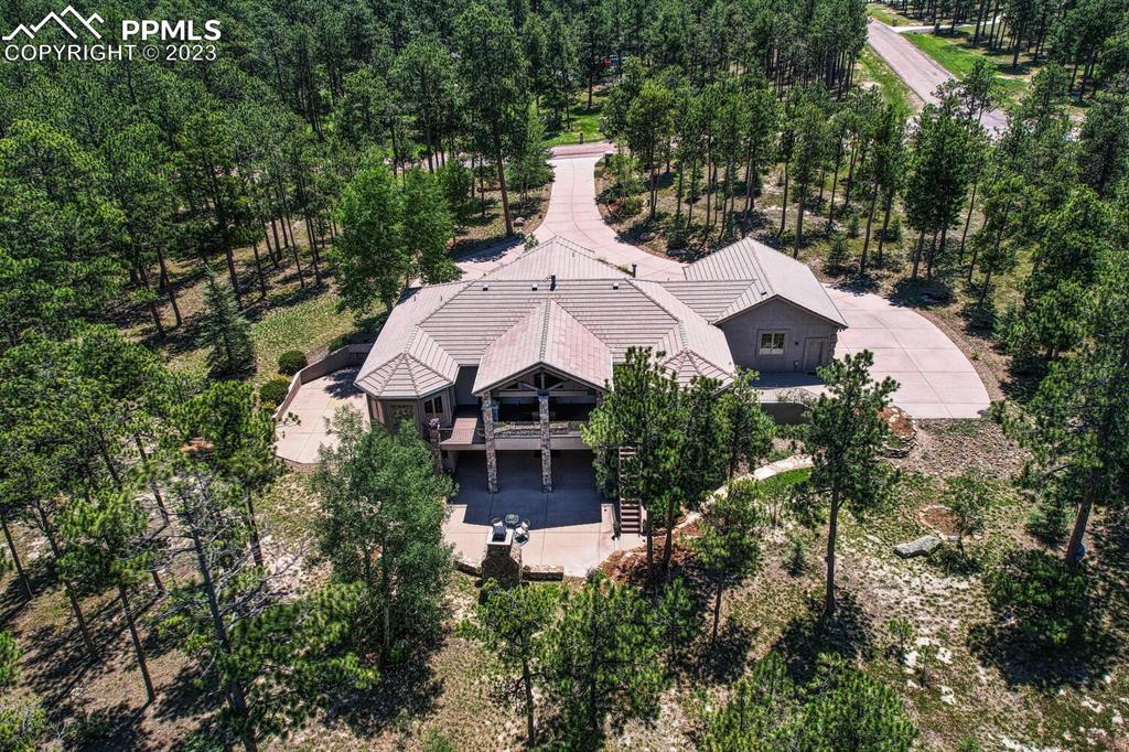 17890 Queensmere Drive Monument, CO 80132 - Photo 50 of 50 an aerial view of a house with a yard and large trees