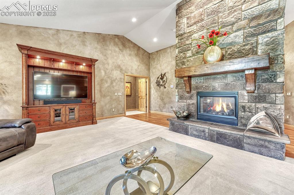 17890 Queensmere Drive Monument, CO 80132 - Photo 7 of 50 a living room with fireplace furniture and a flat screen tv