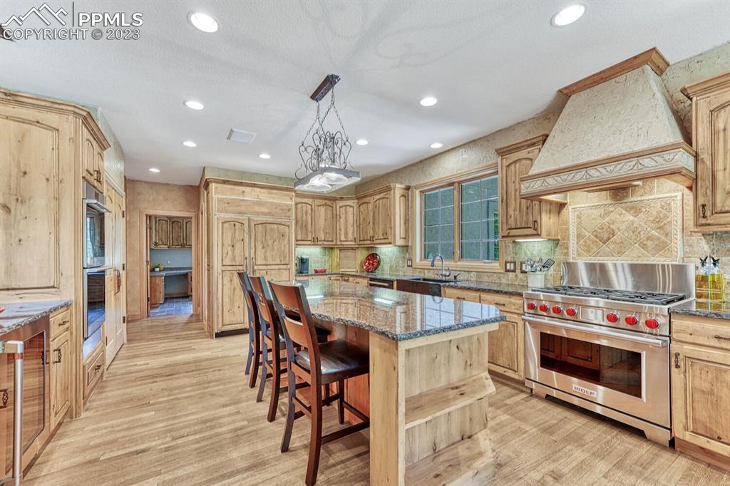 17890 Queensmere Drive Monument, CO 80132 - Photo 9 of 50 a kitchen with stainless steel appliances a stove a sink a refrigerator and chairs