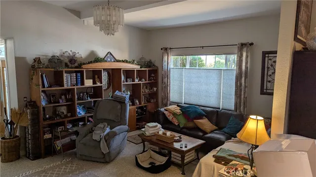 a living room with furniture a window and gym equipment