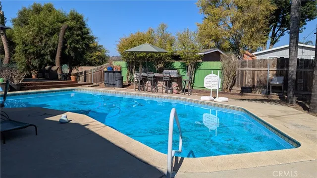 a view of a swimming pool with sitting area