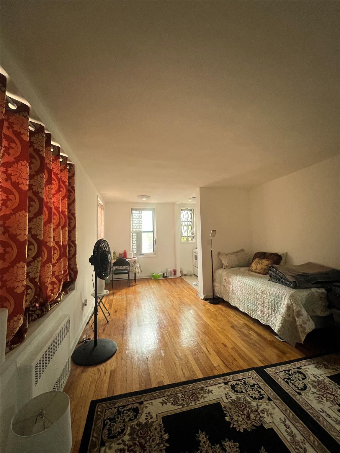 84-23 Manton Street, Unit 4A Queens, NY 11435 - Photo 12 of 18 a room with bed and a window