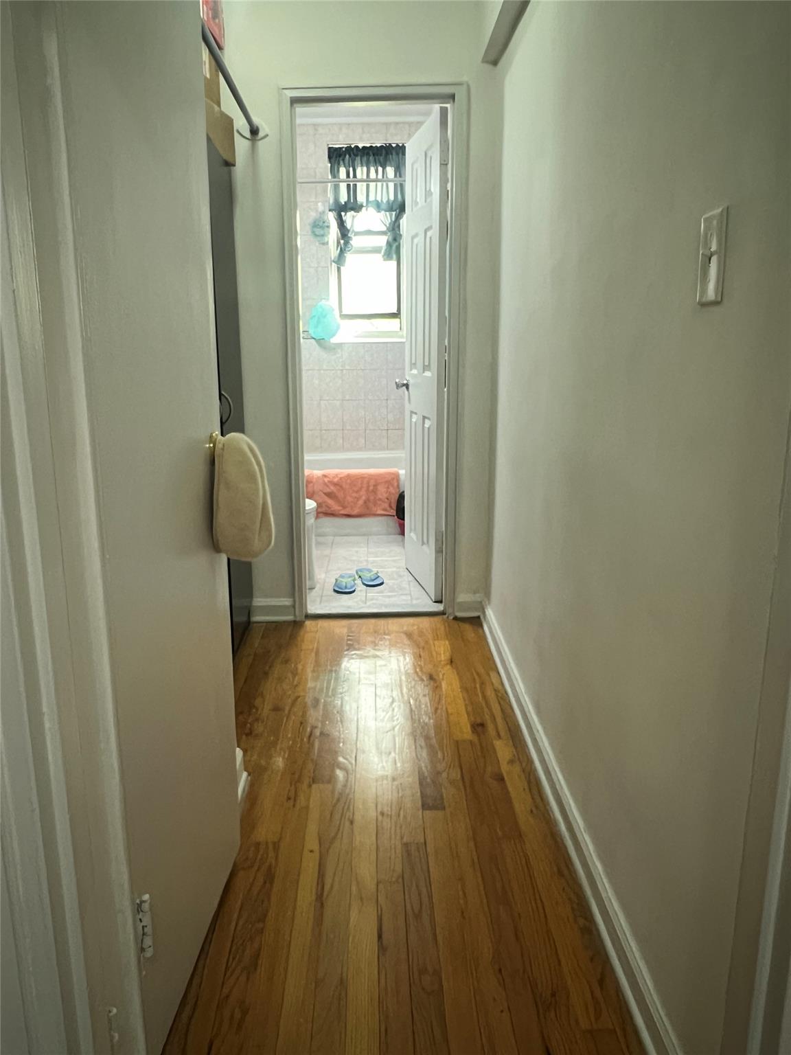 84-23 Manton Street, Unit 4A Queens, NY 11435 - Photo 14 of 18 a view of empty room with wooden floor