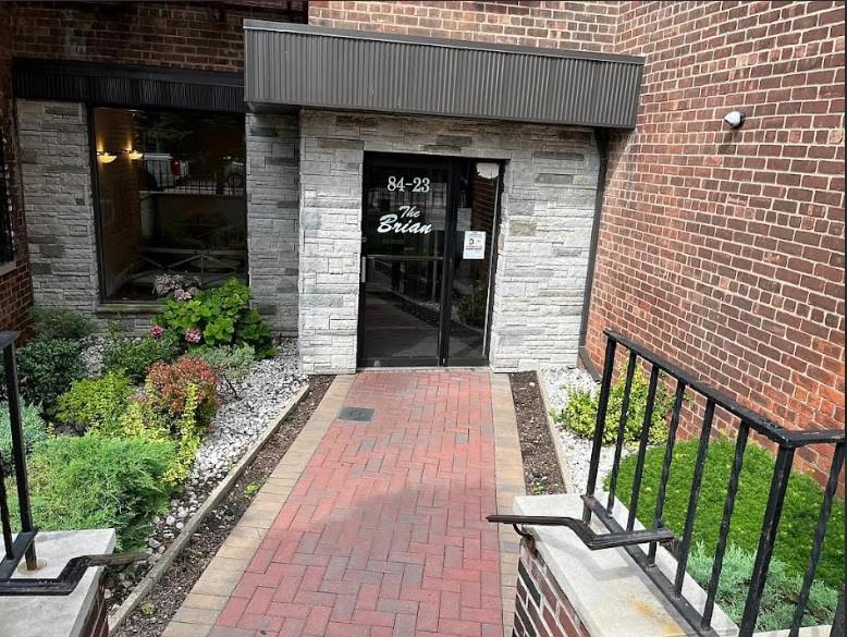 84-23 Manton Street, Unit 4A Queens, NY 11435 - Photo 2 of 18 a stone house with outdoor space