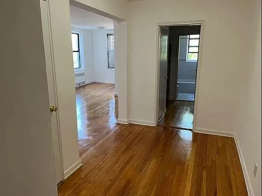 a view of hallway with wooden floor