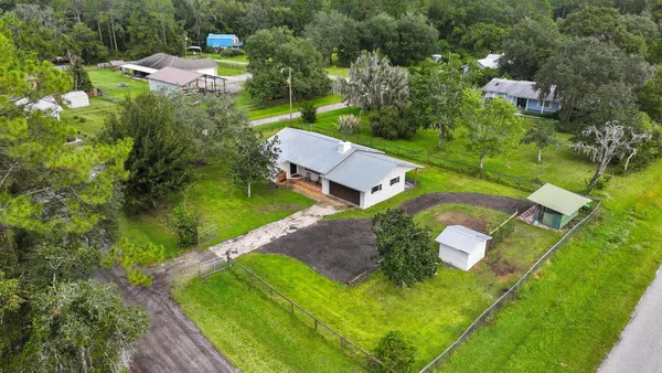 an aerial view of a house with yard swimming pool and outdoor seating