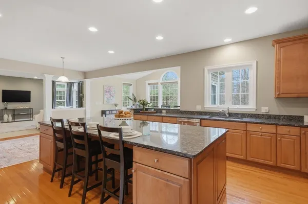 a kitchen with center island table and chairs