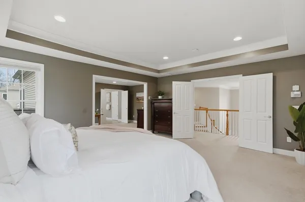 a large white bed in a white room