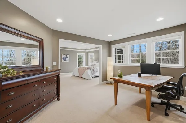 a view of a workspace with furniture and a window