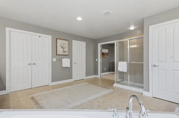 a spacious bathroom with a shower and a sink