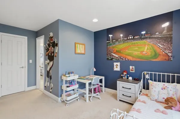 a view of a bedroom with a bed and toys