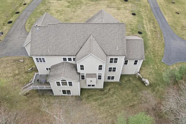 an aerial view of a house with a yard and garage