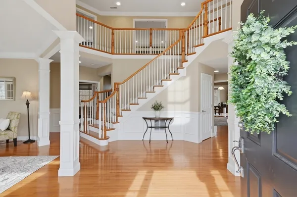a view of entryway and hall with wooden floor