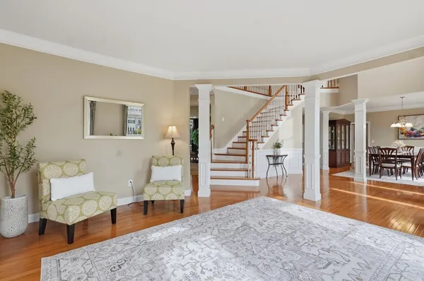 a living room with furniture and a wooden floor