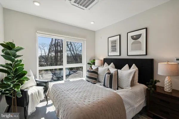 a bed room with a bed and a large window