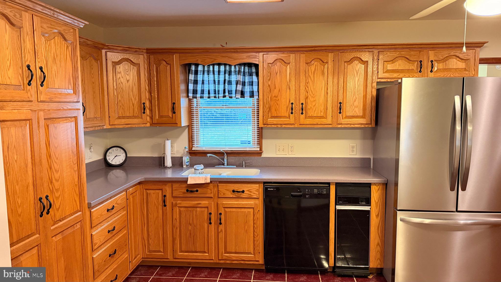 3869 Midstate Road Felton, DE 19943 - Photo 11 of 37 a kitchen with stainless steel appliances granite countertop a refrigerator and a sink