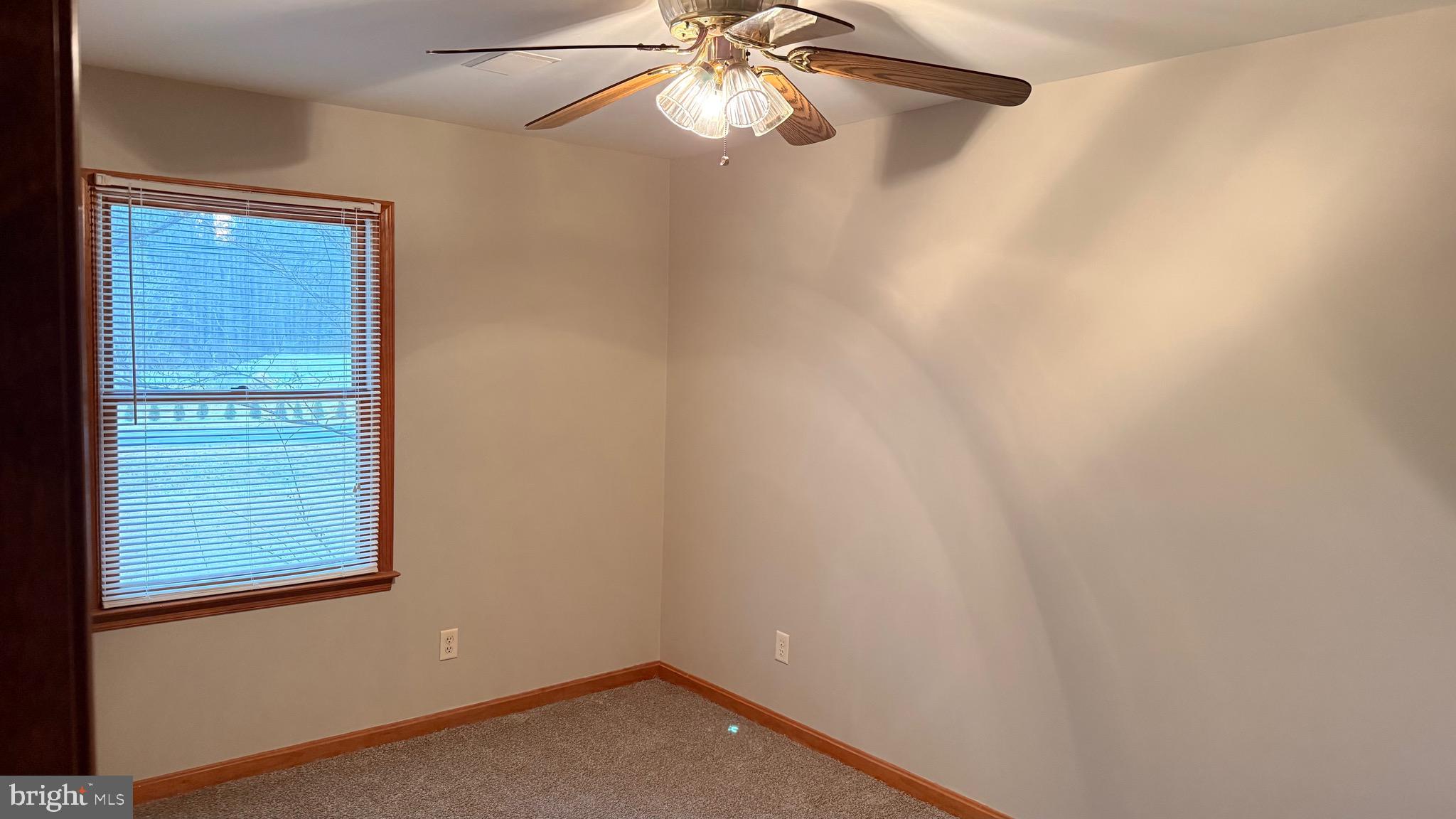 3869 Midstate Road Felton, DE 19943 - Photo 16 of 37 an empty room with a window and a fan