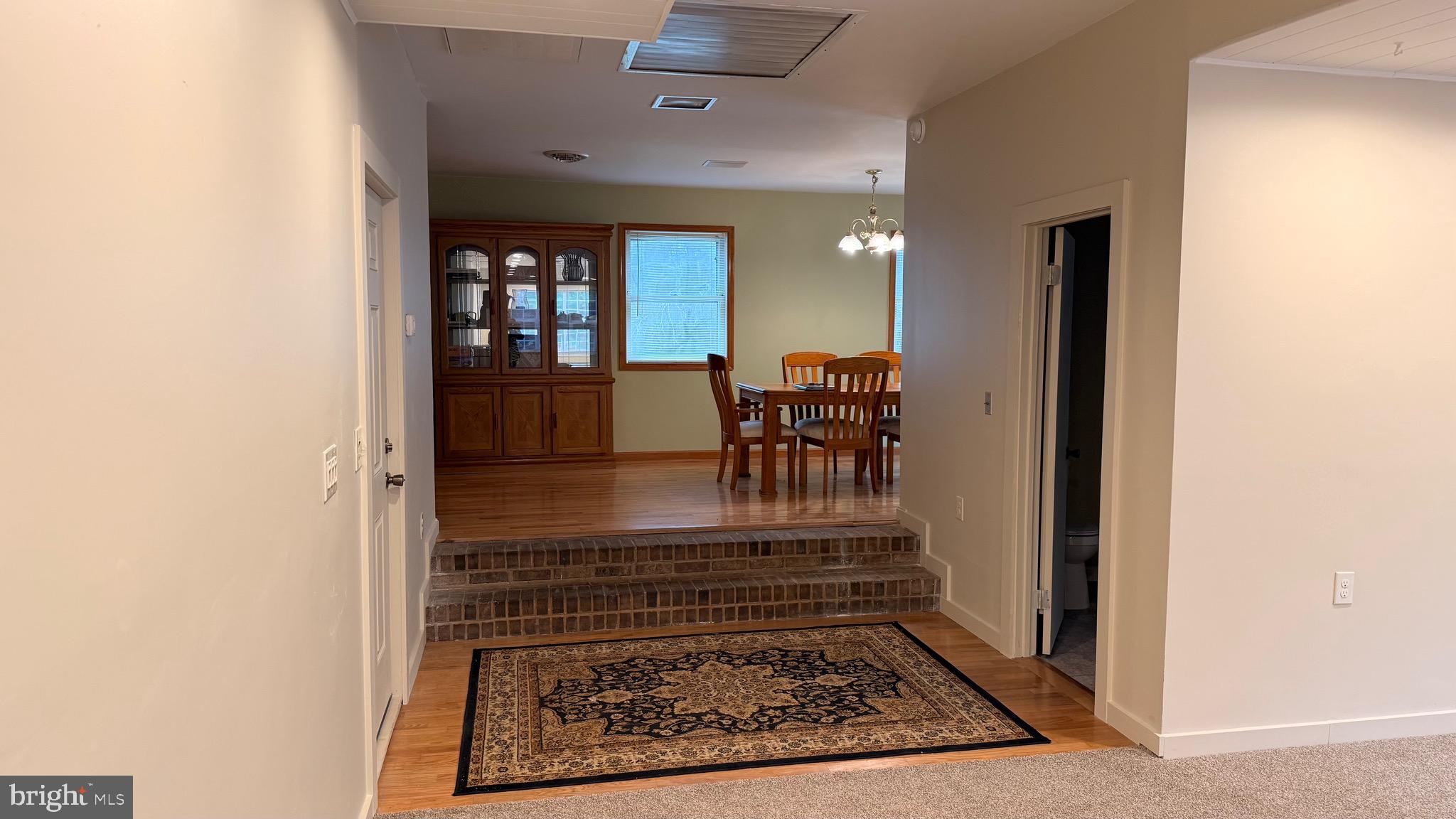 3869 Midstate Road Felton, DE 19943 - Photo 7 of 37 a view of a hallway with dining room and furniture