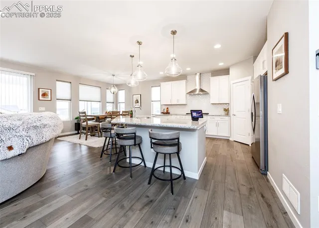 a kitchen with sink table and chairs