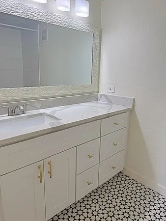a bathroom with a sink a vanity and mirror