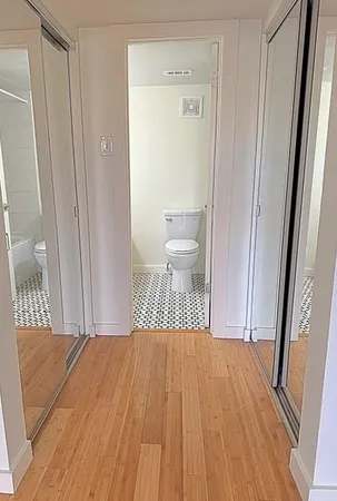 a bedroom with a bed and a mirror