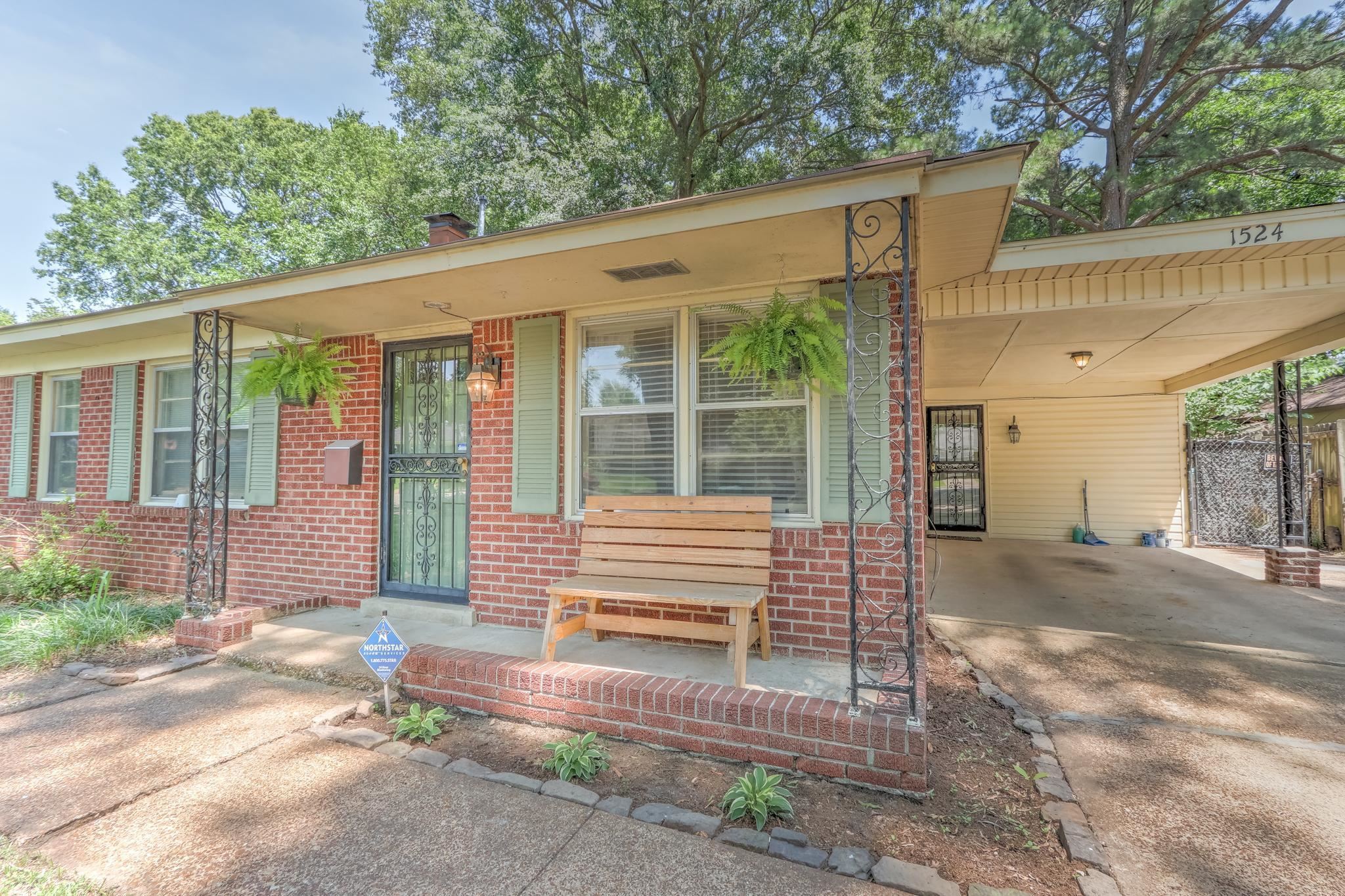 1524 Flamingo Road Memphis, TN 38117 - Photo 18 of 20 a view of backyard with large tree and wooden fence
