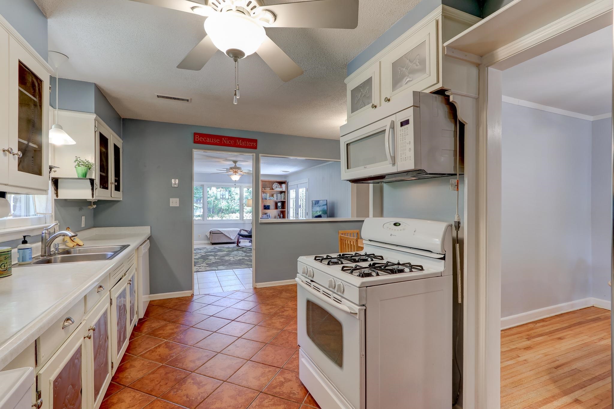 1524 Flamingo Road Memphis, TN 38117 - Photo 5 of 20 a kitchen with stainless steel appliances a sink dishwasher stove and refrigerator with wooden floor