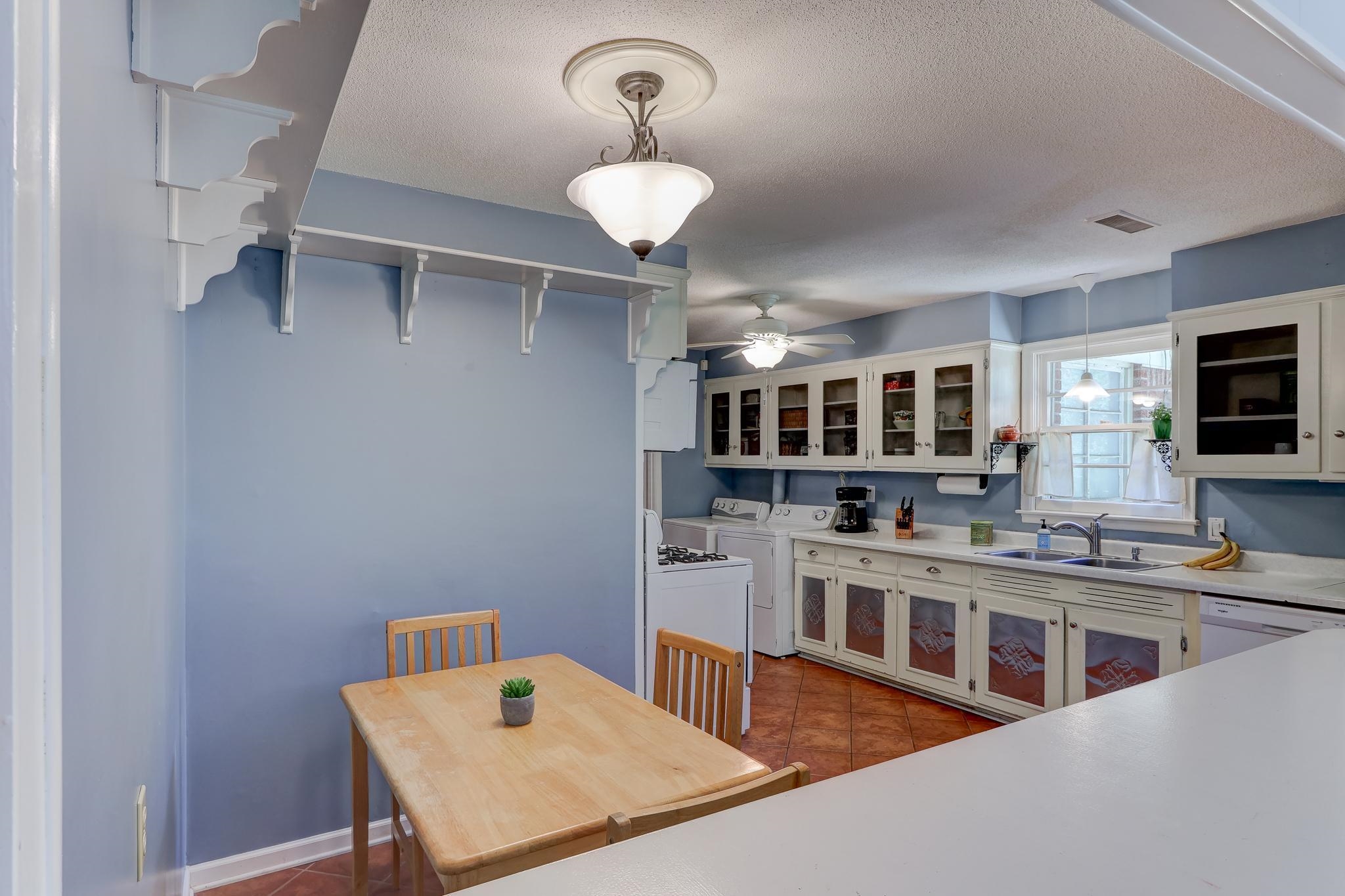 1524 Flamingo Road Memphis, TN 38117 - Photo 7 of 20 a living room with stainless steel appliances kitchen island granite countertop a stove a kitchen island a dining table and chairs
